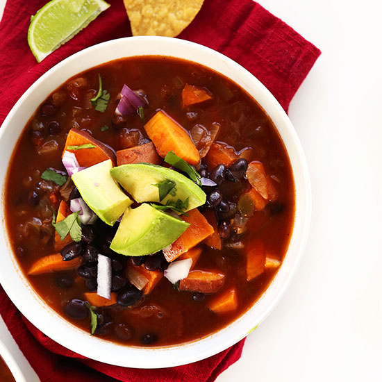 Bowl of Sweet Potato Black Bean Chili topped with diced avocado and cilantro