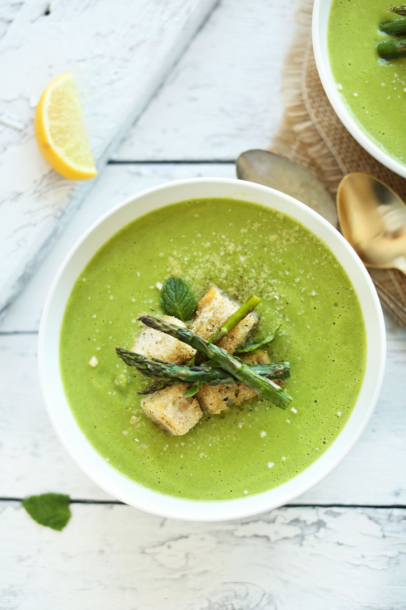 Healthy Vegan Asparagus and Pea Soup topped with crispy croutons and asparagus spears