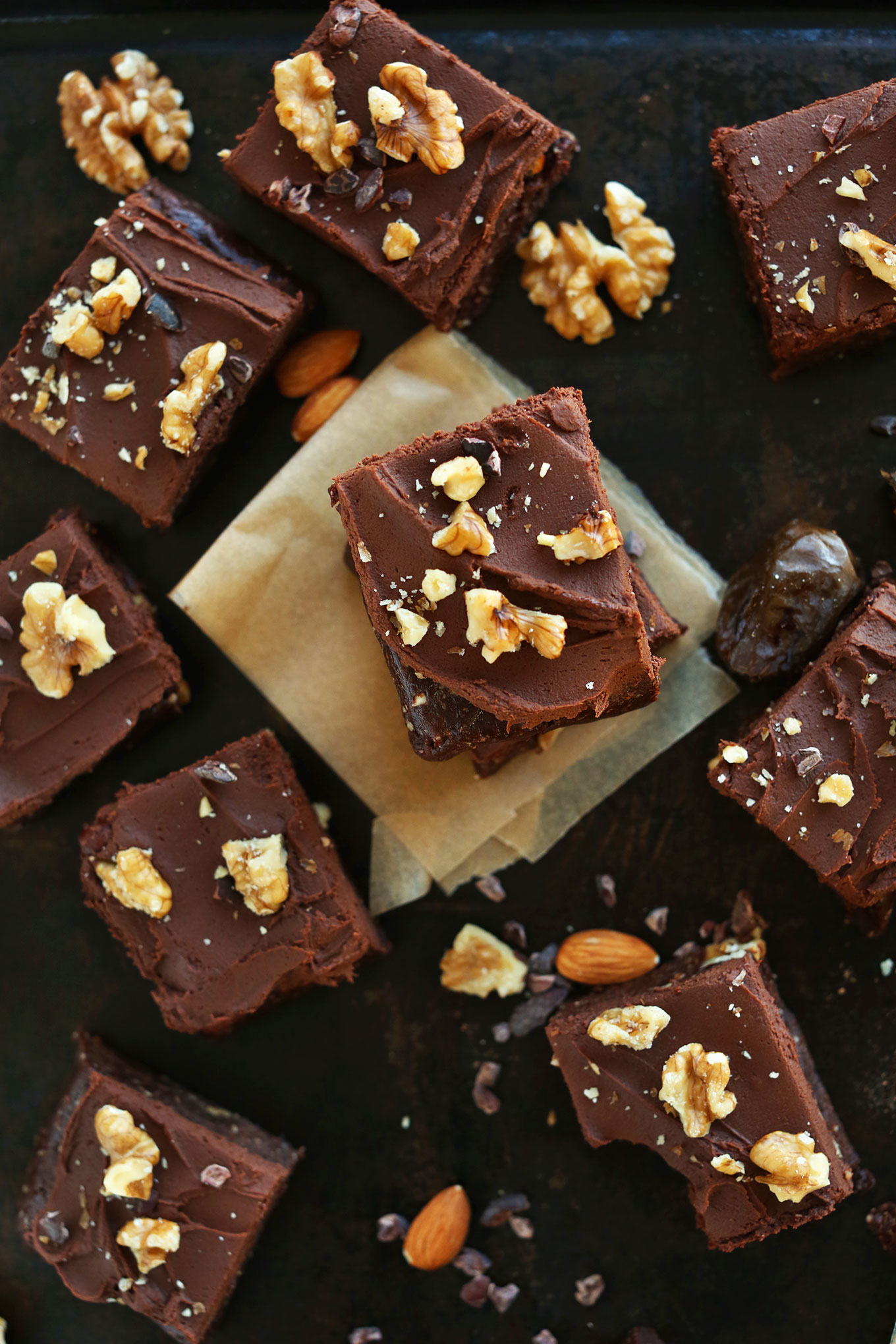 Squares of our delicious dessert recipe of Raw Vegan Brownies with Chocolate Ganache