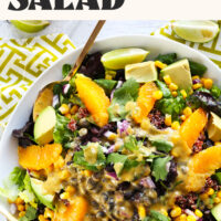 Large bowl filled with our black bean quinoa salad with oranges, avocado, and a creamy avocado chili lime dressing