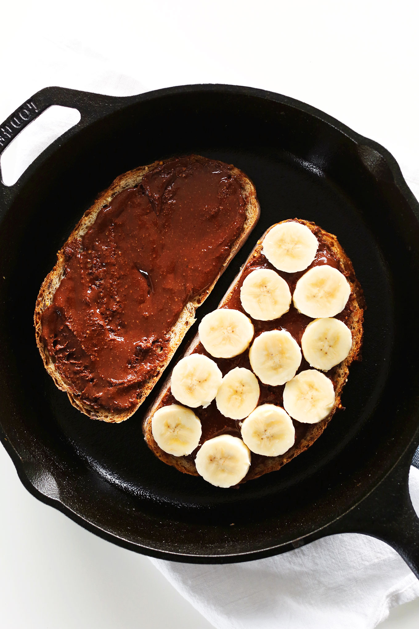 Grilling a Banana Nutella Sandwich in a cast-iron skillet
