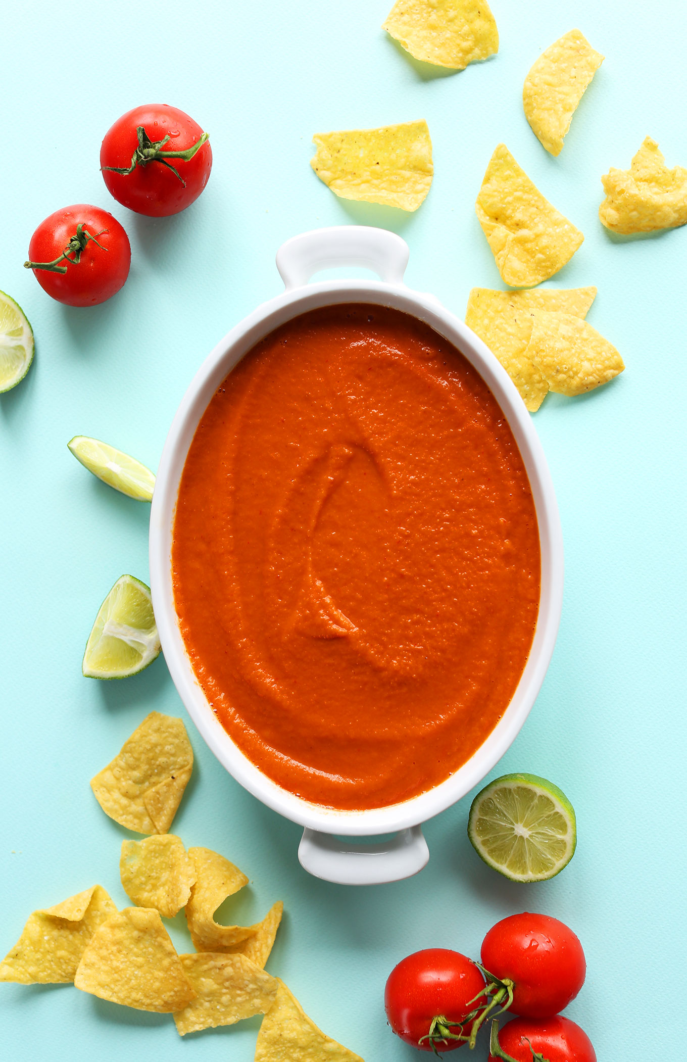 Tortilla chips alongside a dish filled with our Creamy Blended Red Salsa recipe
