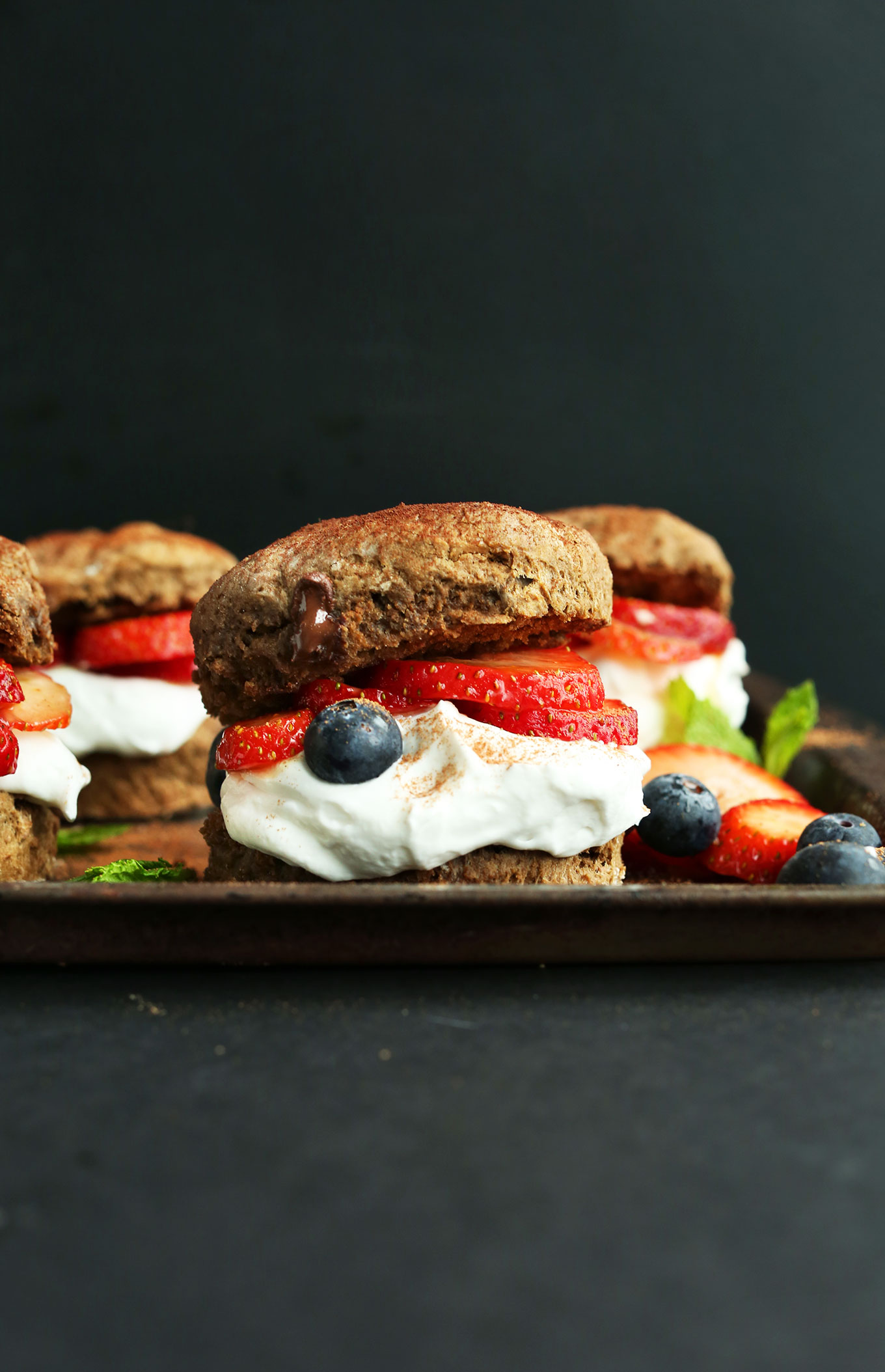 Easy-to-make vegan Chocolate Shortcakes filled with coconut whip, fresh strawberries, and fresh blueberries
