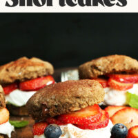 Side view of vegan chocolate strawberry shortcakes with coconut whipped cream
