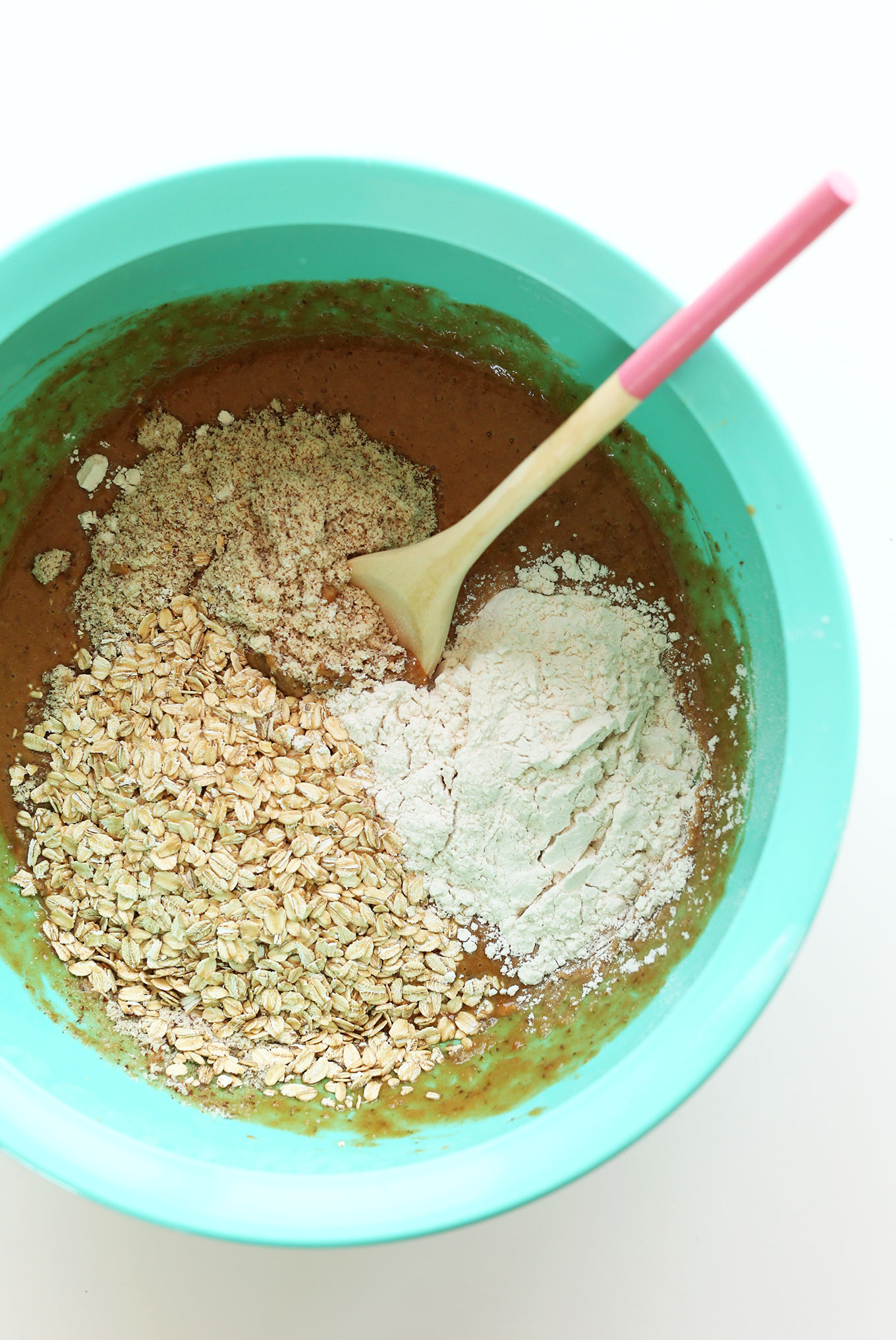 Stirring wet and dry ingredients together for our delicious gluten-free vegan PB&J Muffins