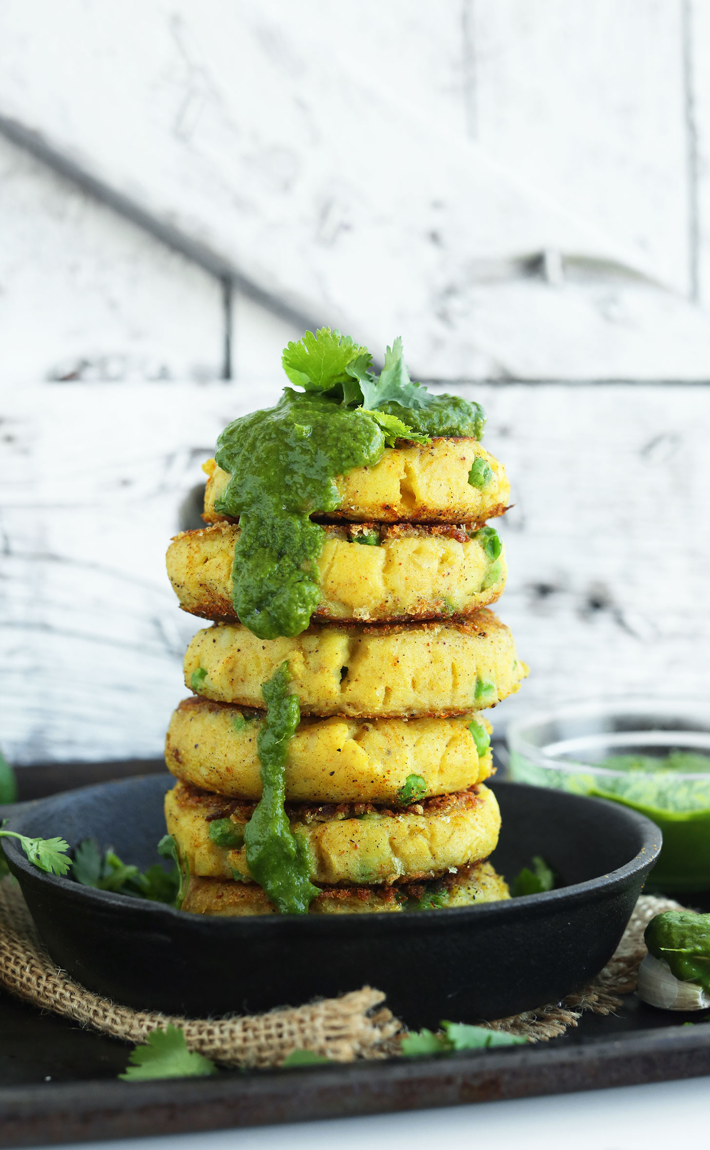 Stack of Samosa-Inspired Potato Cakes dripping with delicious Green Chutney