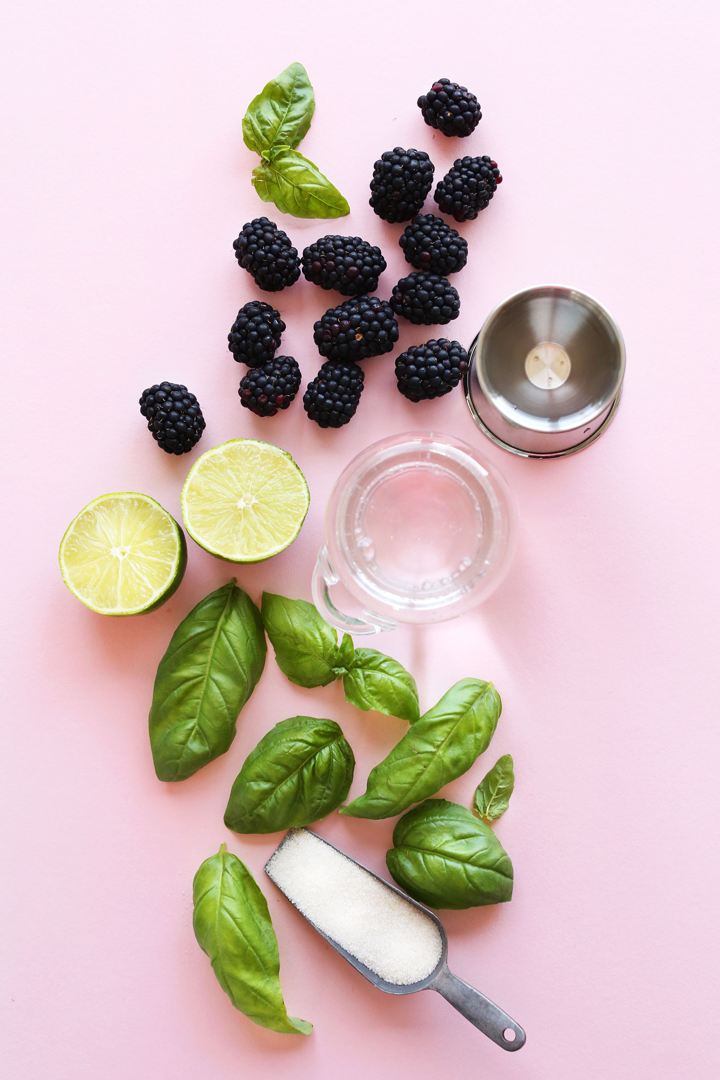 Blackberries, lime, basil, and sugar for making a summer cocktail