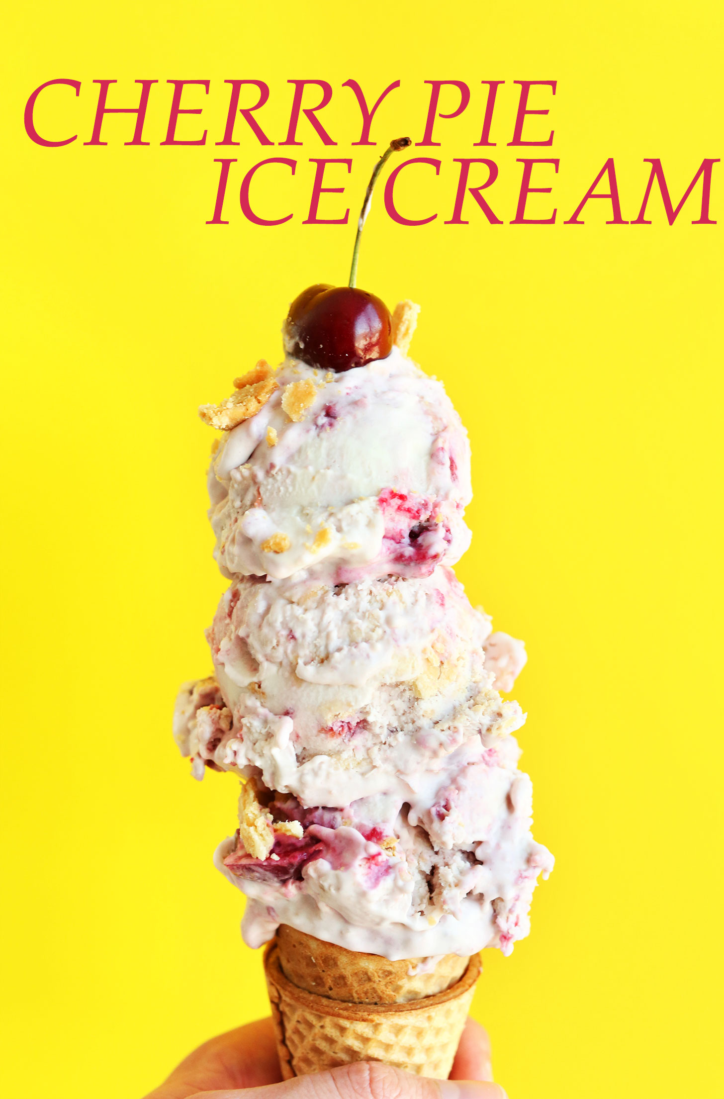 Triple scoop homemade Vegan Cherry Pie Ice Cream on a sugar cone