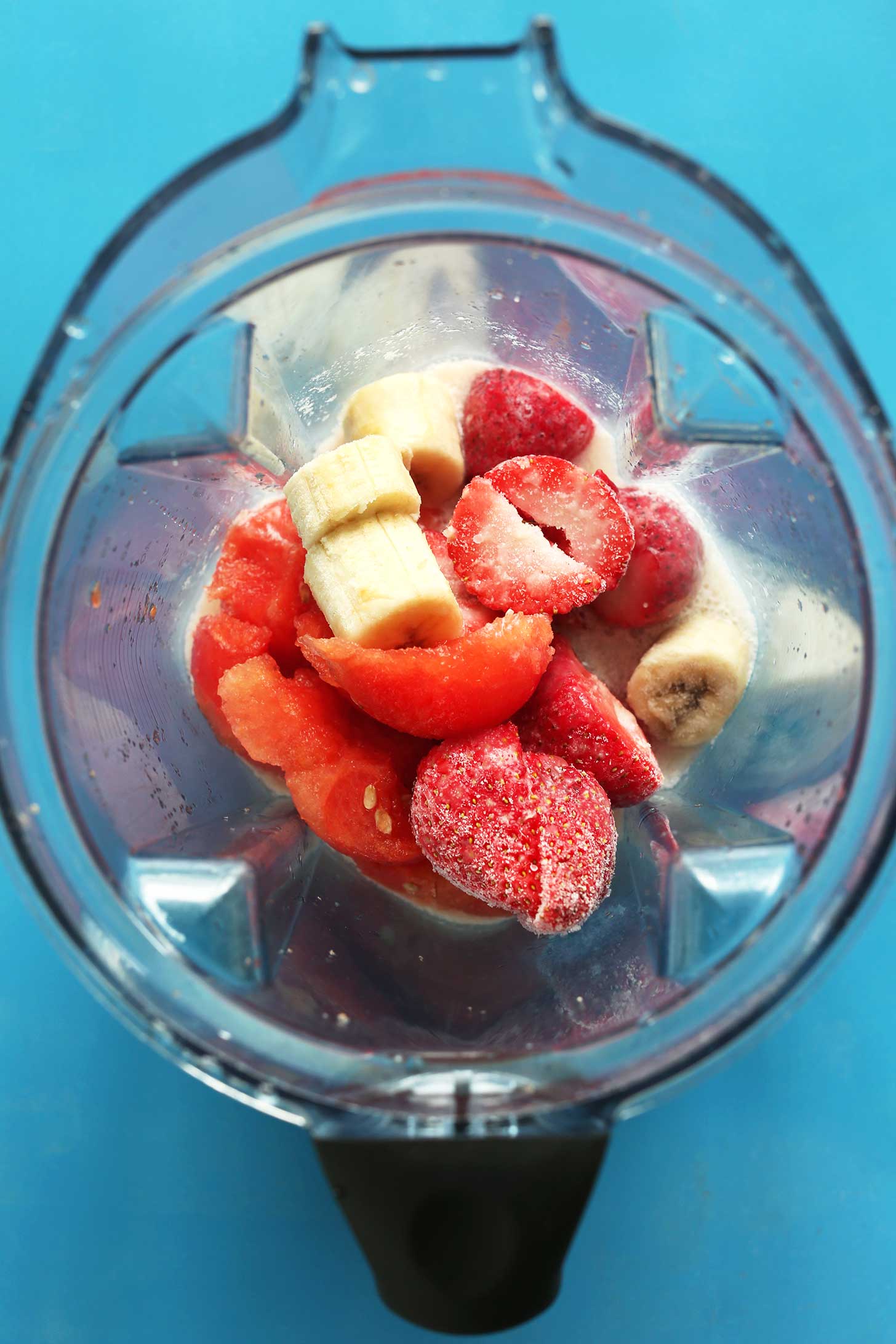 Watermelon, strawberries, and banana in a blender for making a refreshing smoothie