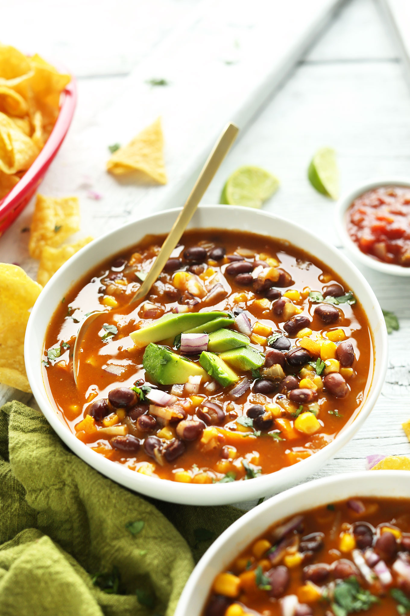 Gold spoon in a bowl of Chipotle Black Bean Tortilla Soup