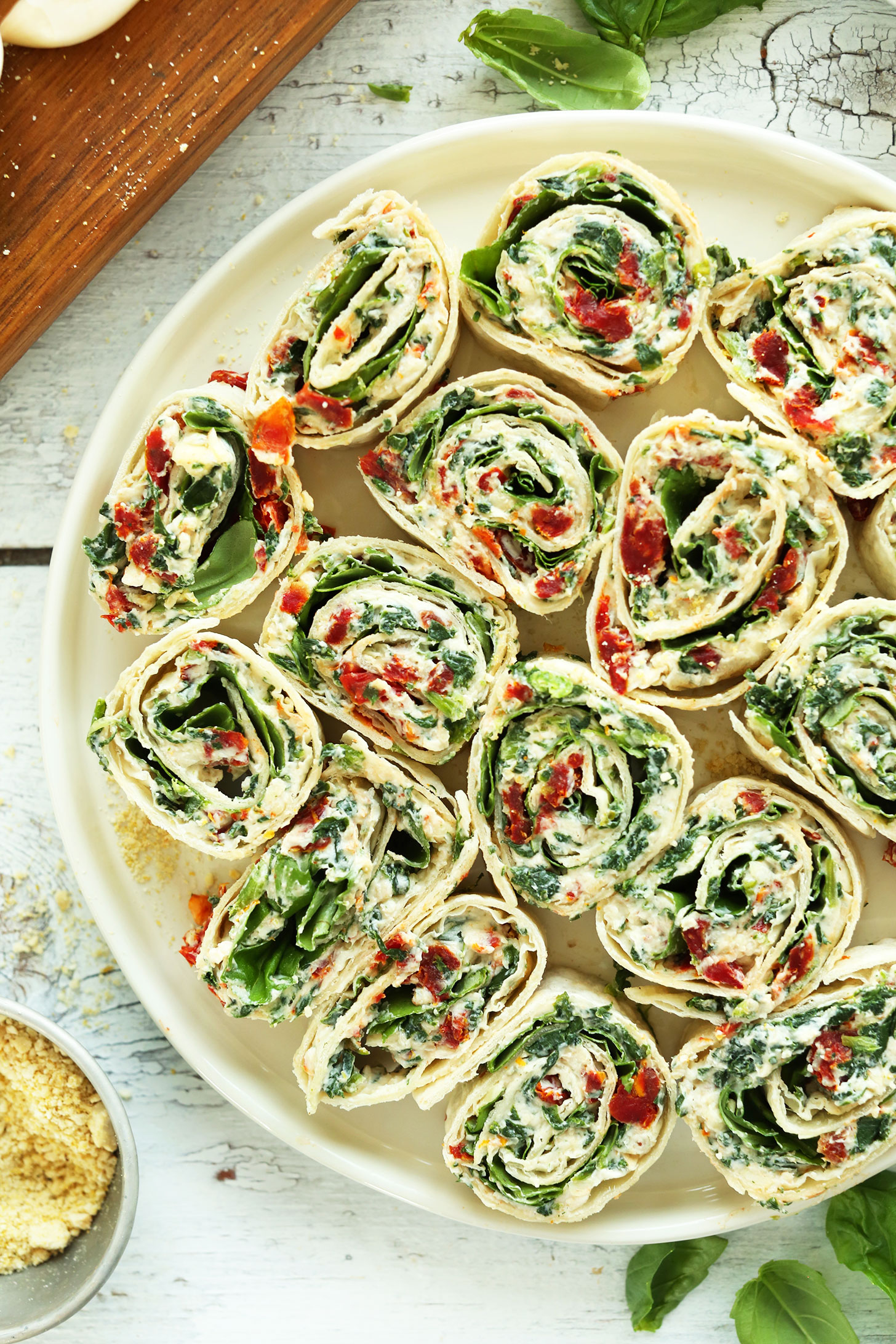 Big plate of Sun-Dried Tomato and Basil Pinwheels for a crowd-pleasing summer appetizer