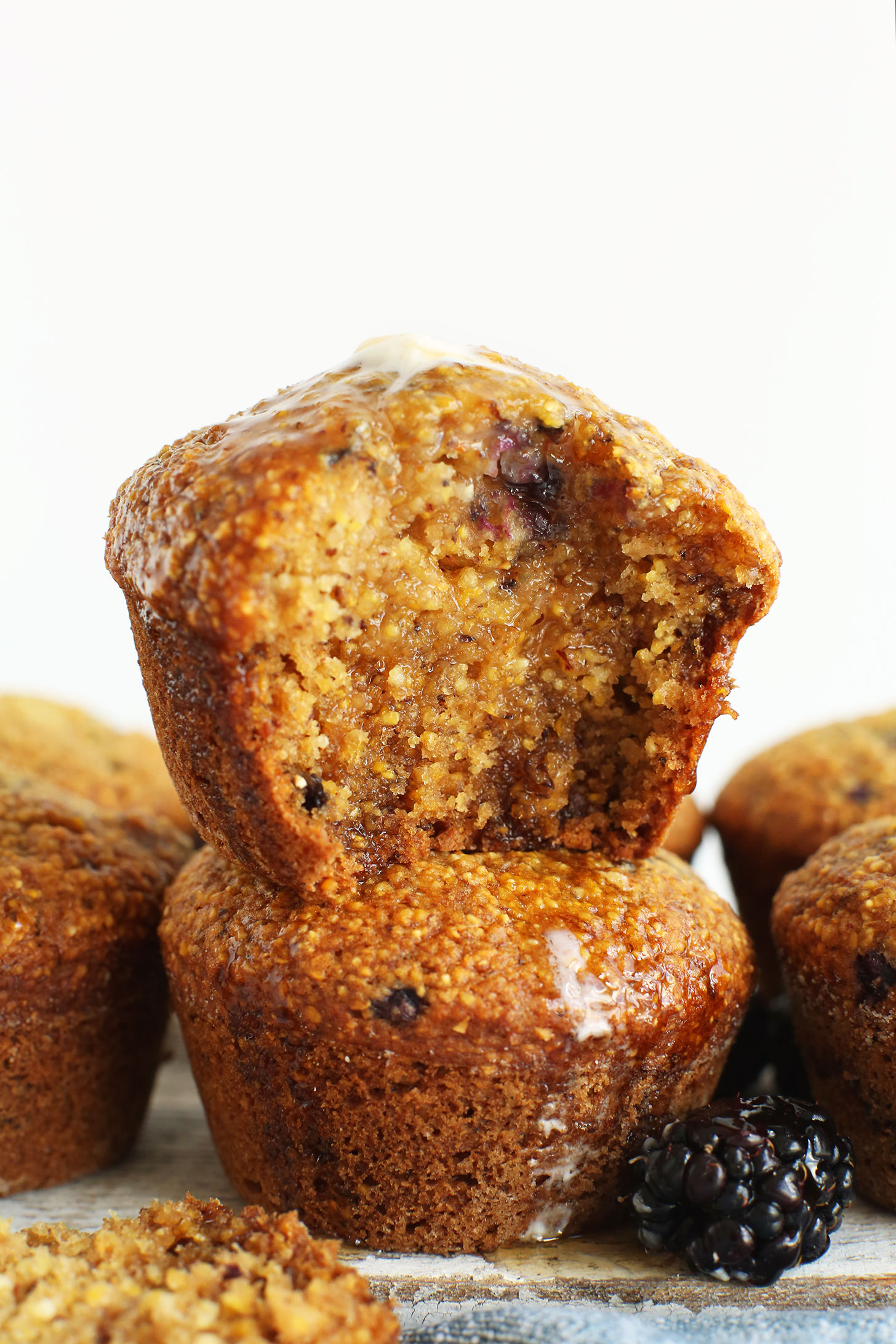 Stack of vegan Blackberry Cornmeal Muffins for a delicious vegan snack