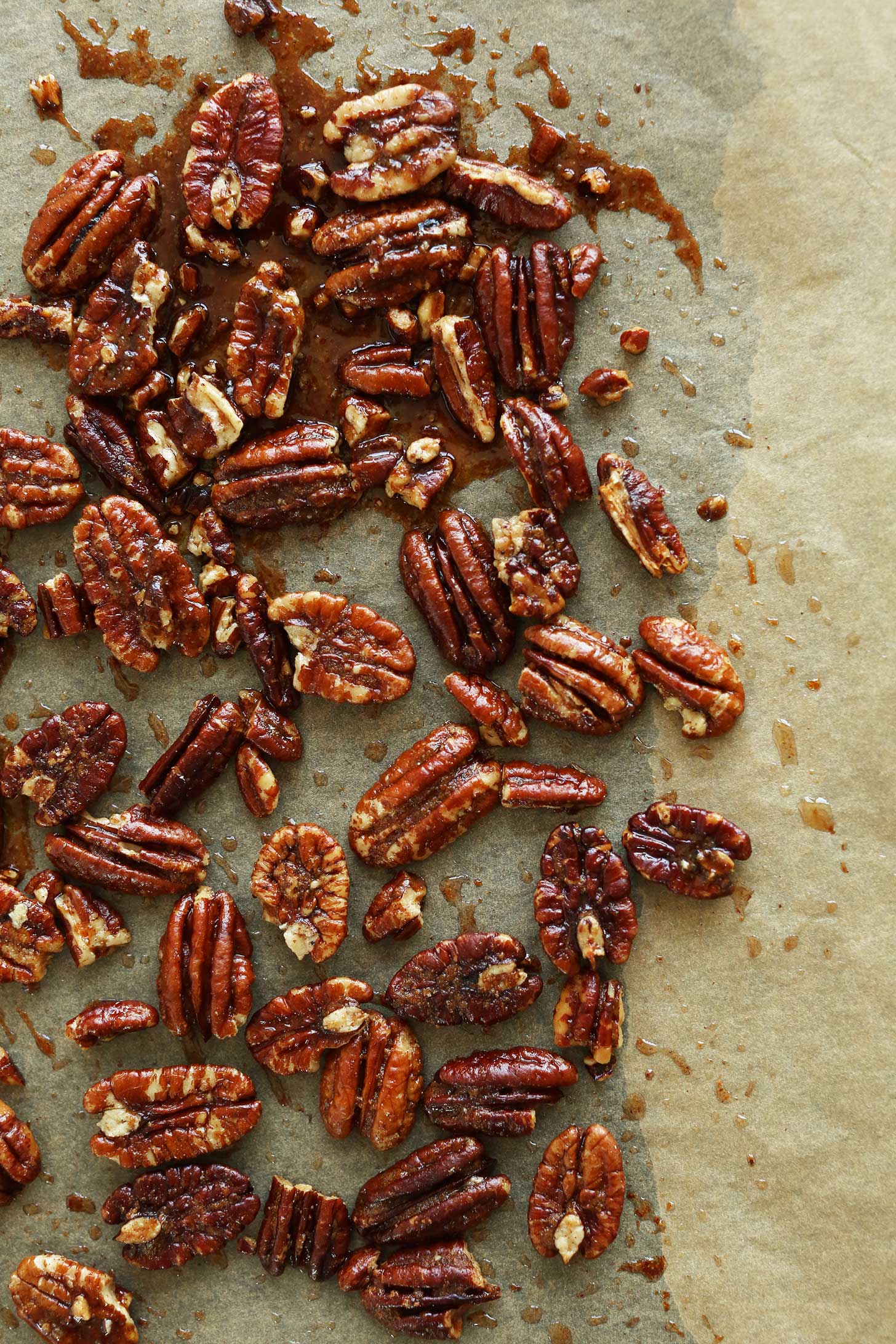 Making Brown Sugar Roasted Pecans on a parchment-lined baking sheet