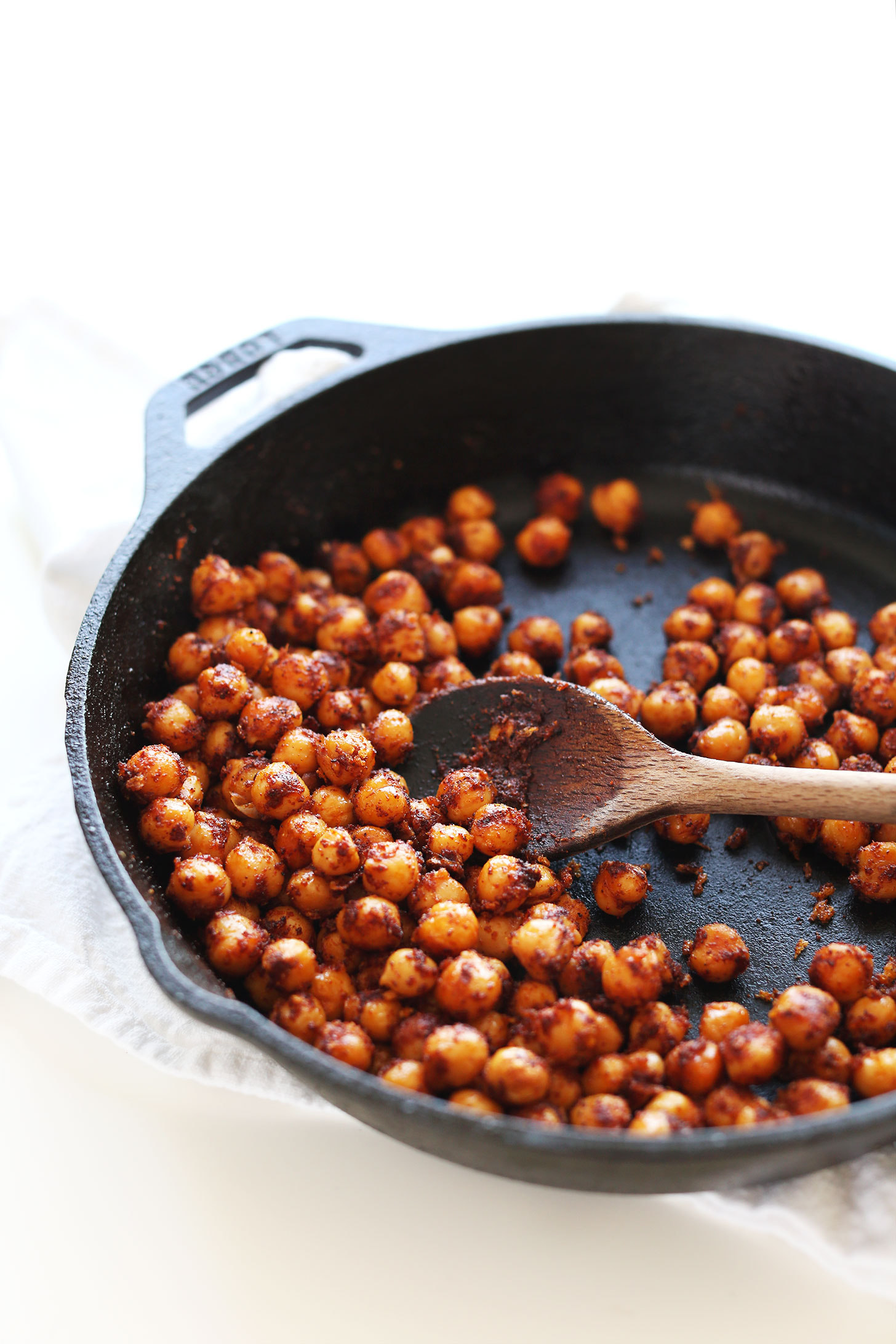 Cooking Easy Spiced Chickpeas in a cast-iron skillet for adding to avocado boats