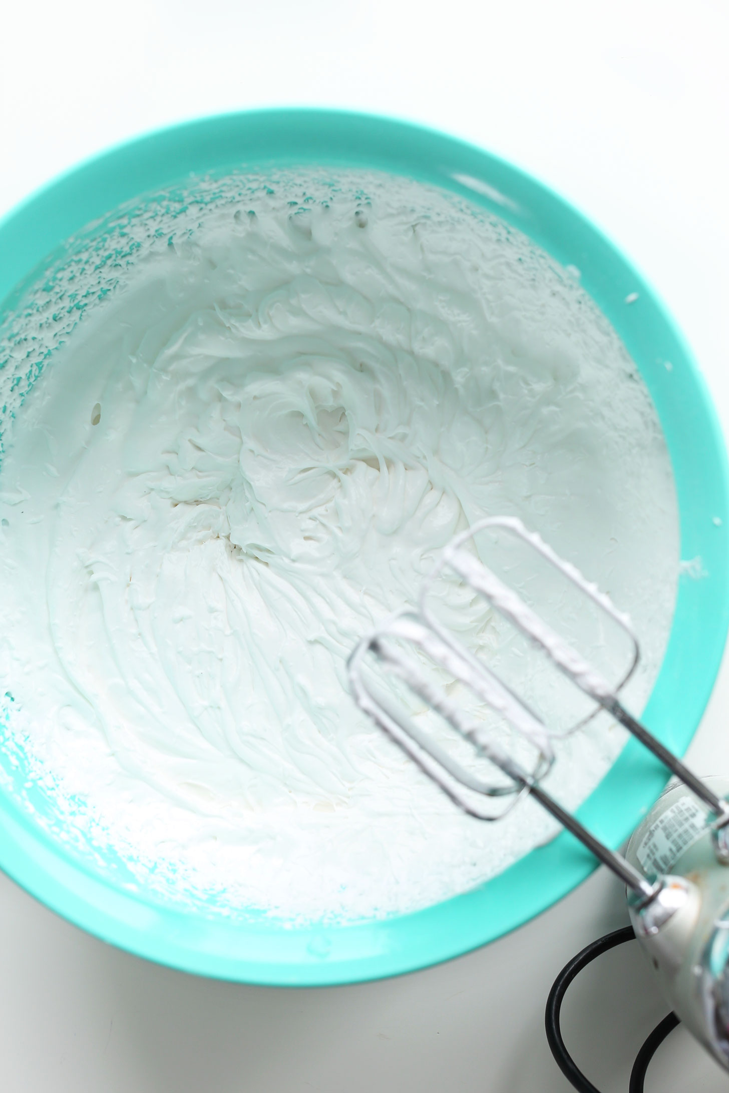Using a hand mixer to make homemade Coconut Whipped Cream