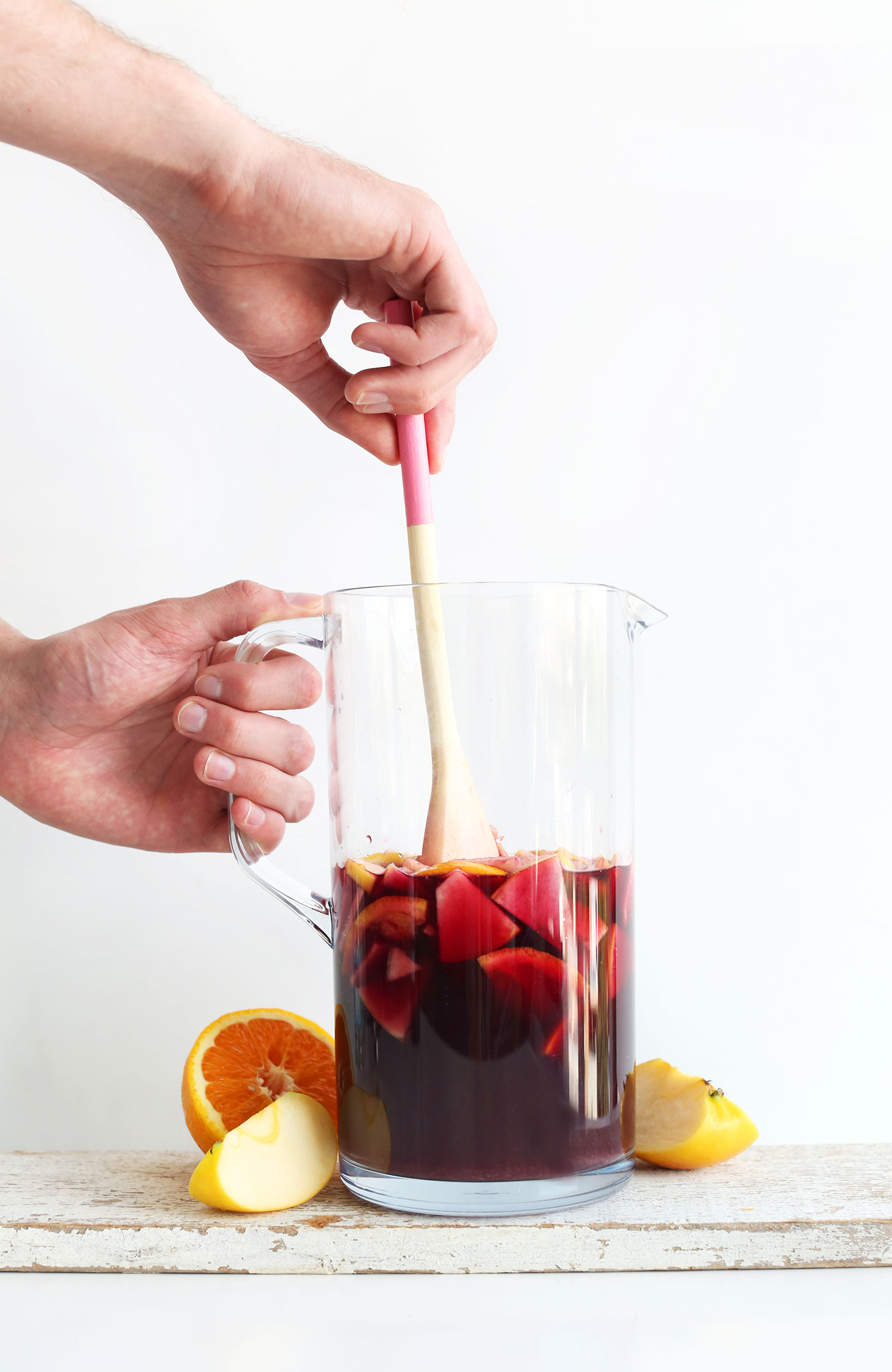 Stirring Traditional Red Sangria for a homemade summer drink