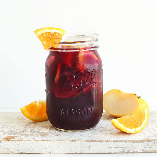 Fresh orange wedge on the rim of a jar of Traditional Red Sangria