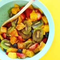 Blue mixing bowl filled with our Spicy Fruit Salad recipe