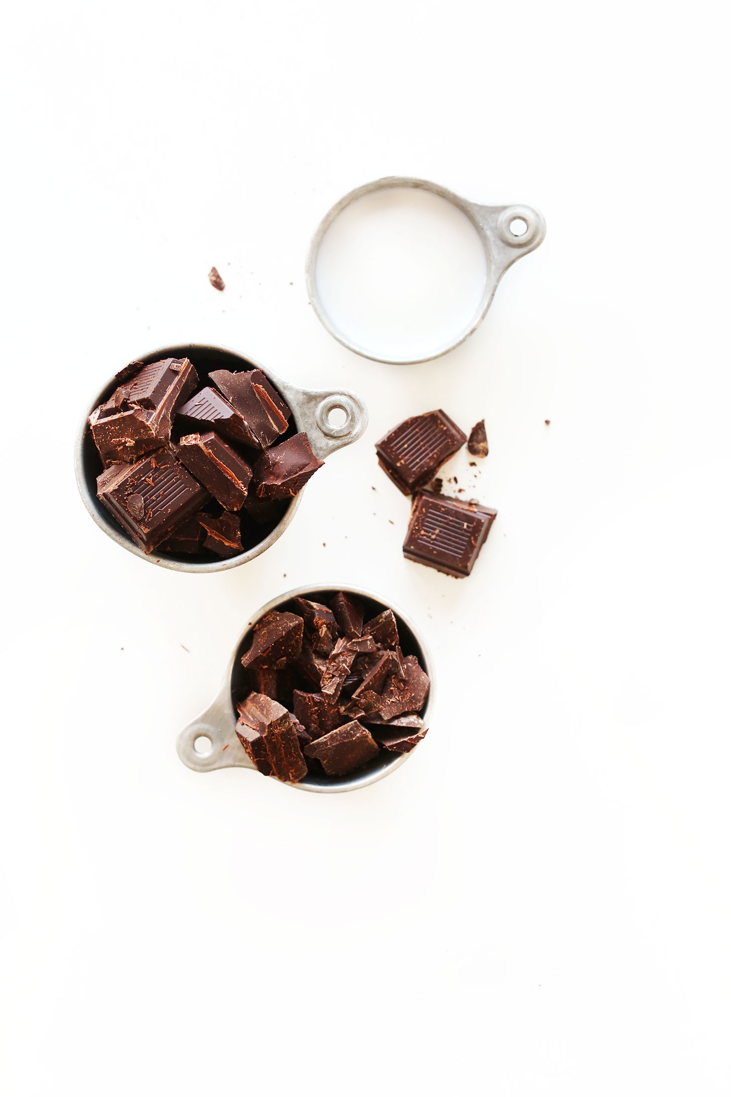 Measuring cups of dark chocolate and coconut milk for making super simple vegan Dark Chocolate Truffles