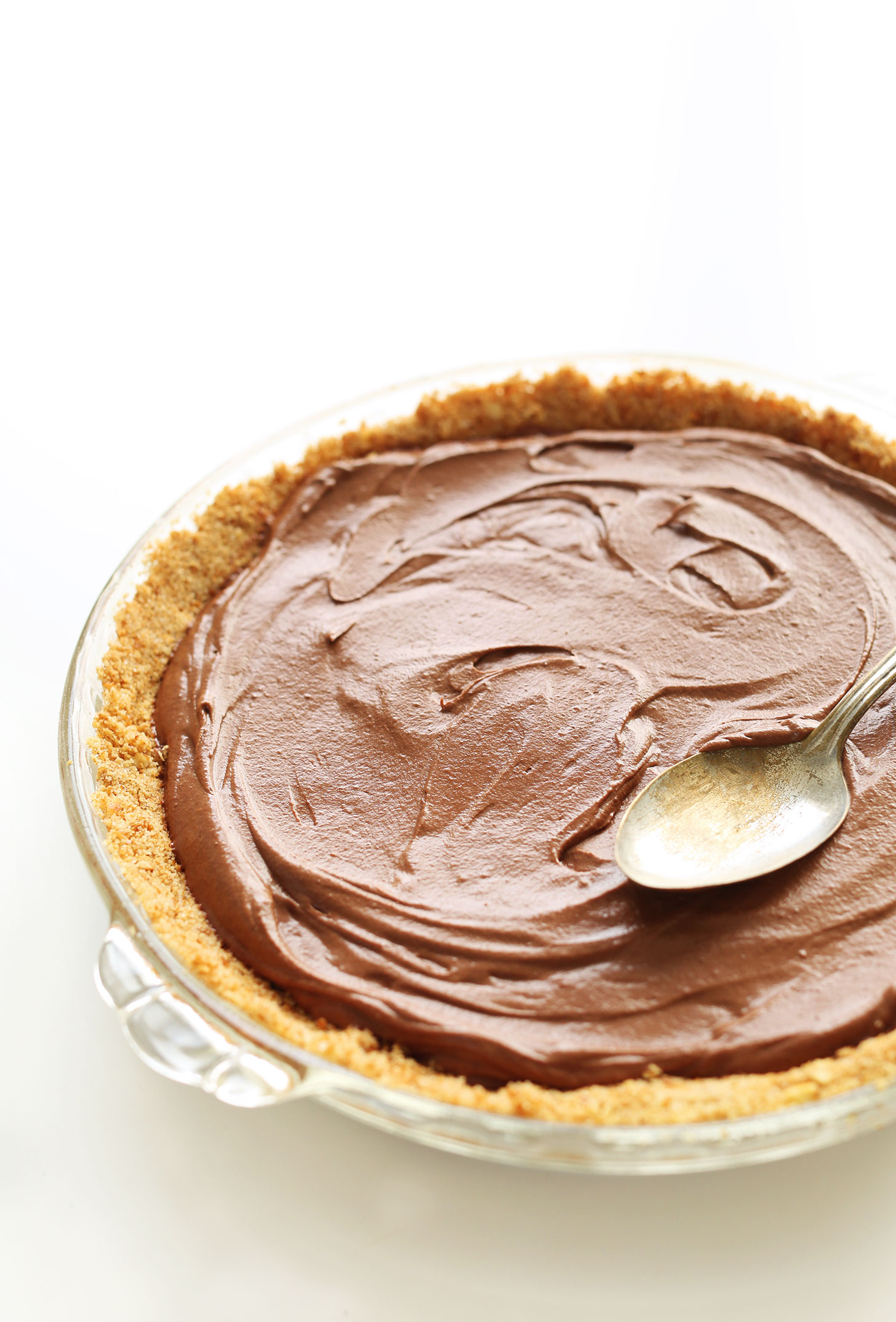 Using the back of a spoon to even out the chocolate filling of our vegan pie