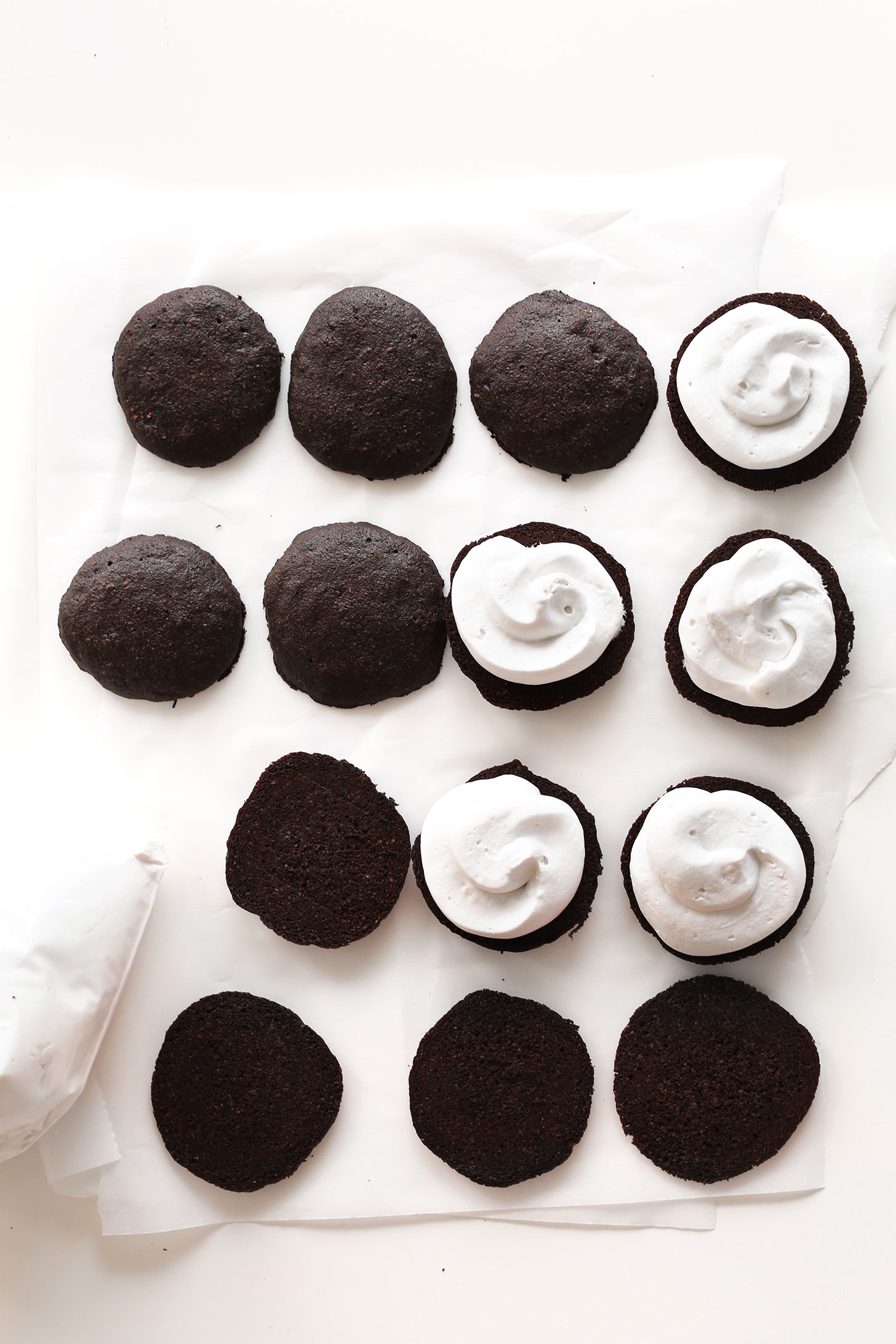 Cake portion of vegan whoopie pies- some of which have a swirl of coconut whipped cream