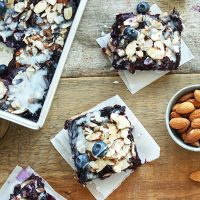 Blueberry Pie Bars on parchment paper and in a pan