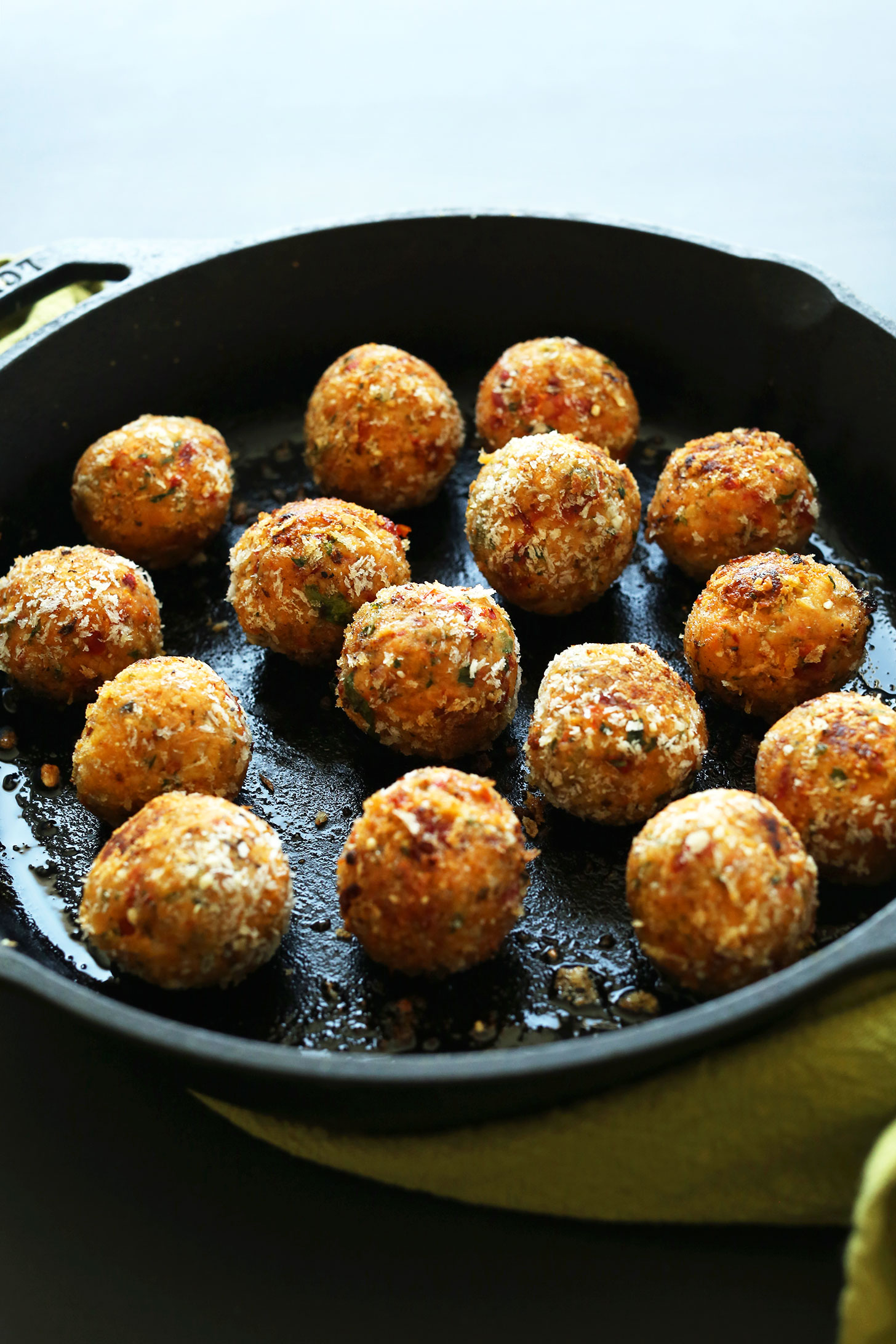 Cooking vegan chickpea meatballs in a cast-iron skillet