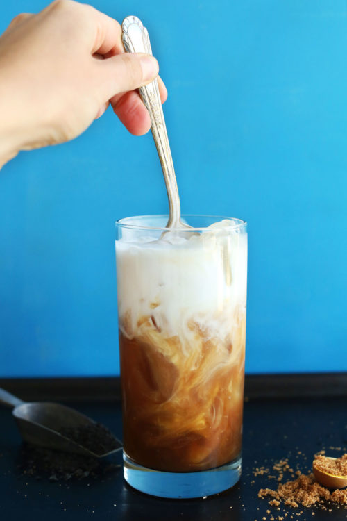 Stirring Thai Iced Tea for a refreshing vegan summer beverage
