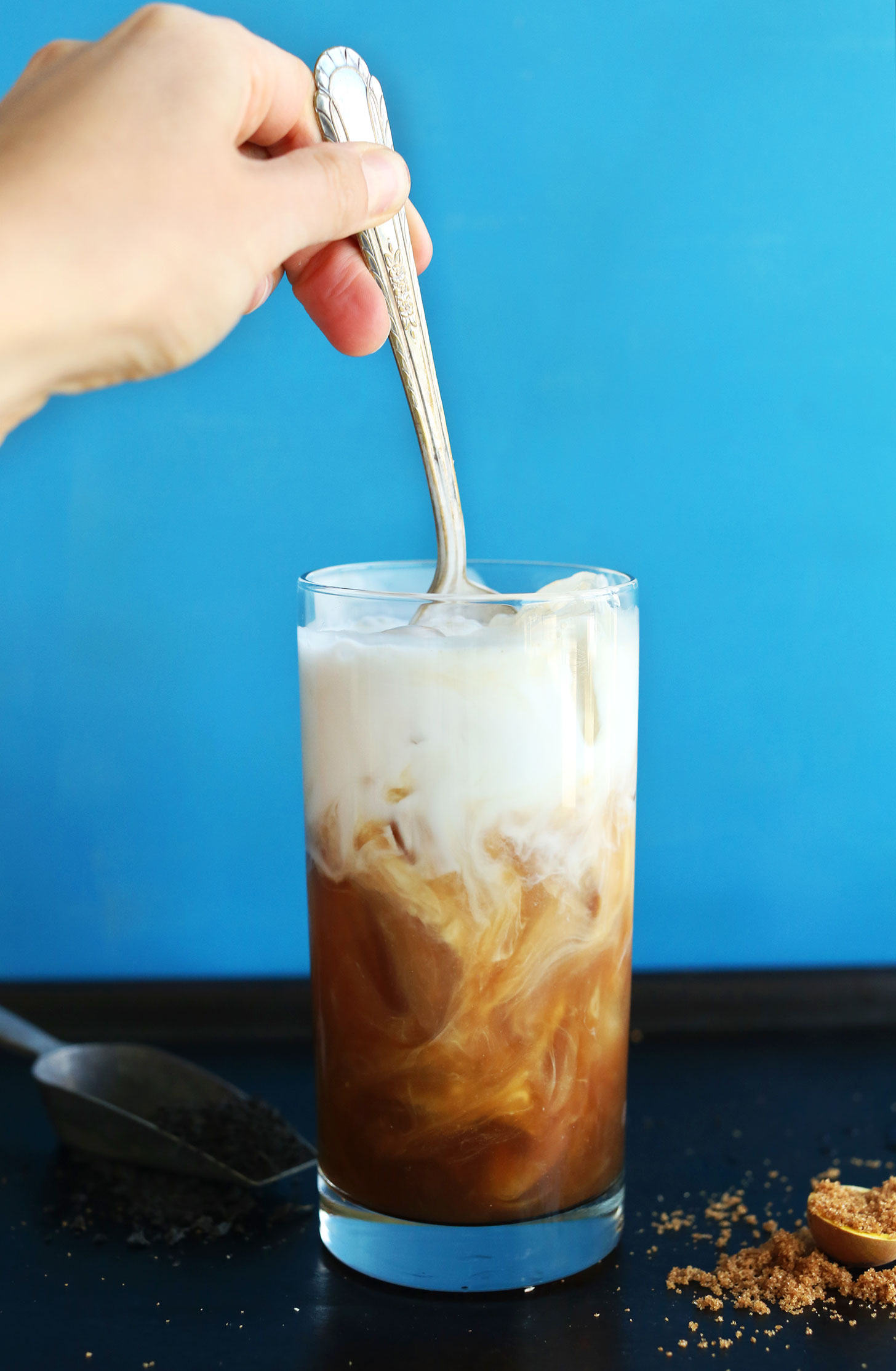 Stirring together creamy coconut milk and tea for Easy Vegan Coconut Thai Iced Tea