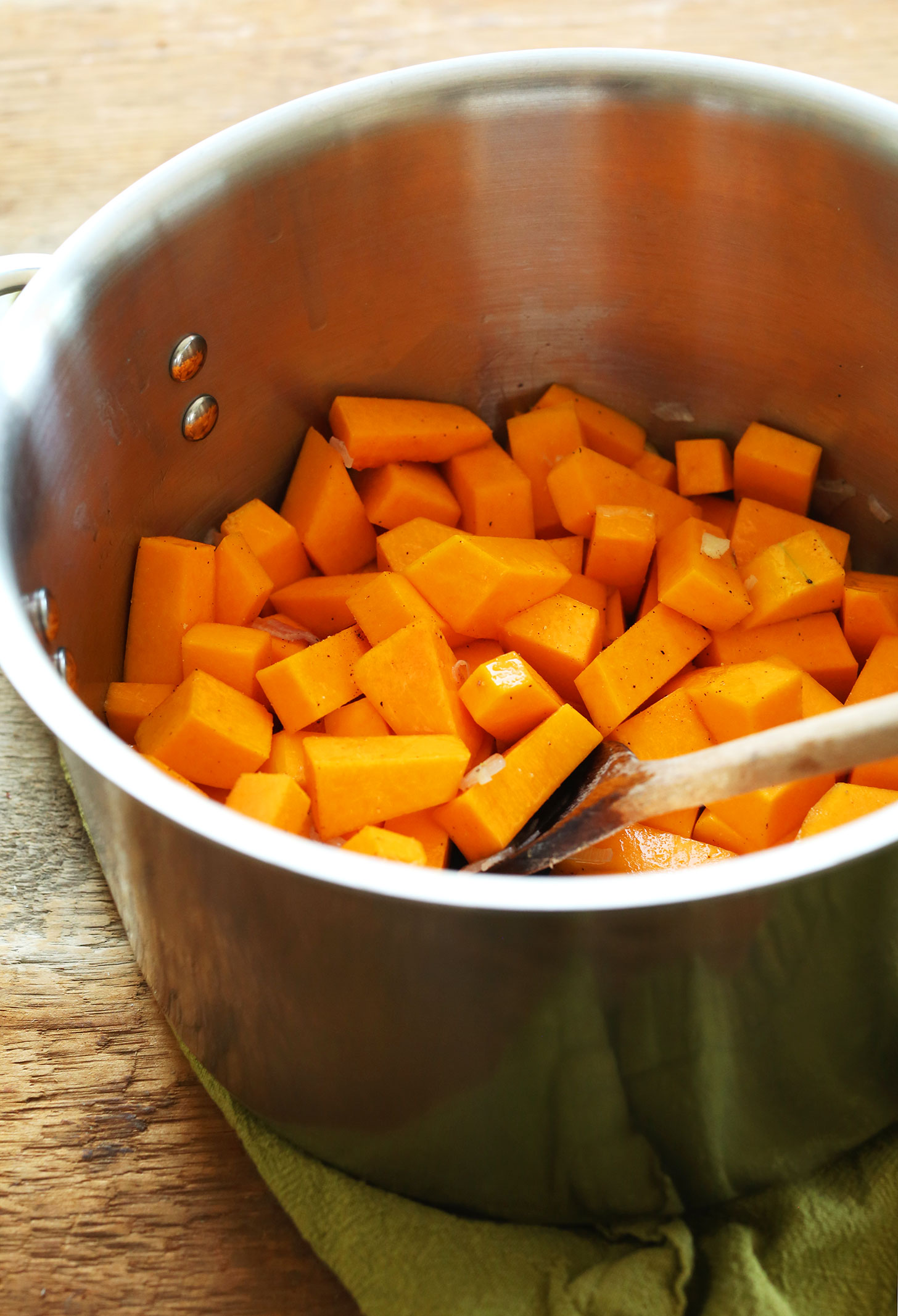 Cooking cubes of butternut squash as part of our post on How to Make Butternut Squash soup
