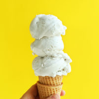 Cone with scoops of coconut vanilla vegan ice cream