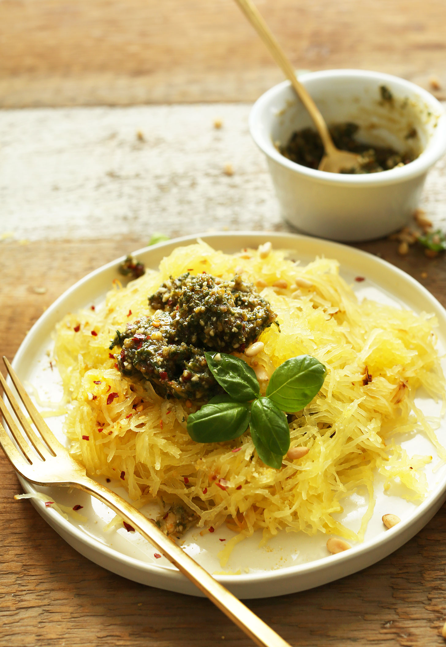 Plate of our delicious gluten-free vegan Spaghetti Squash Pasta recipe topped with pesto