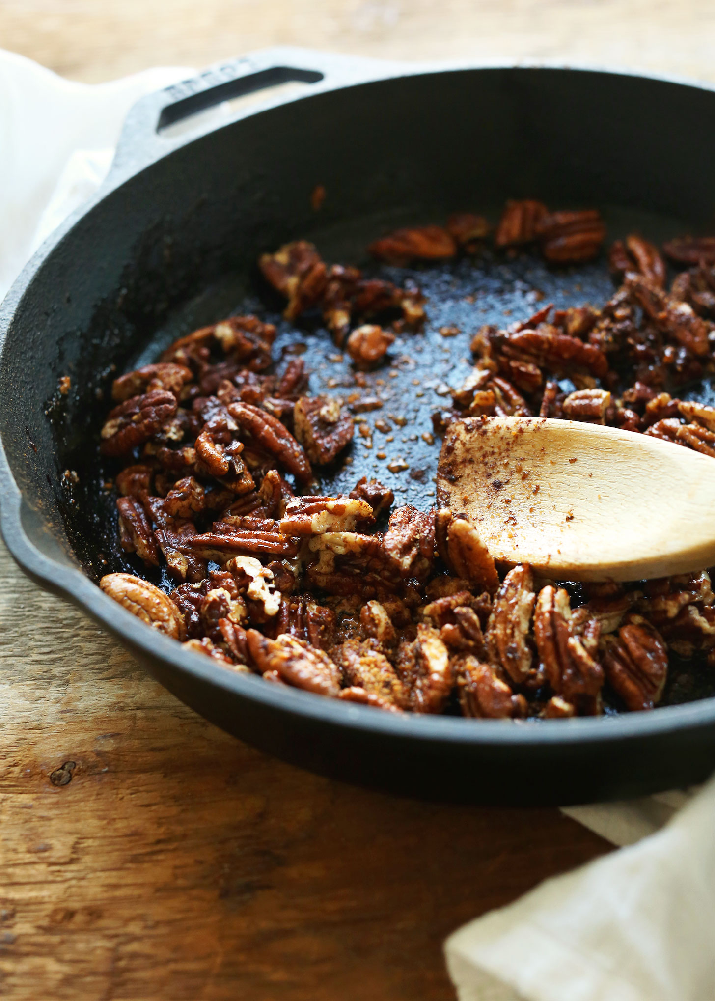 Making Maple Cinnamon Pecans in a cast-iron skillet for a gluten-free vegan Thanksgiving dish