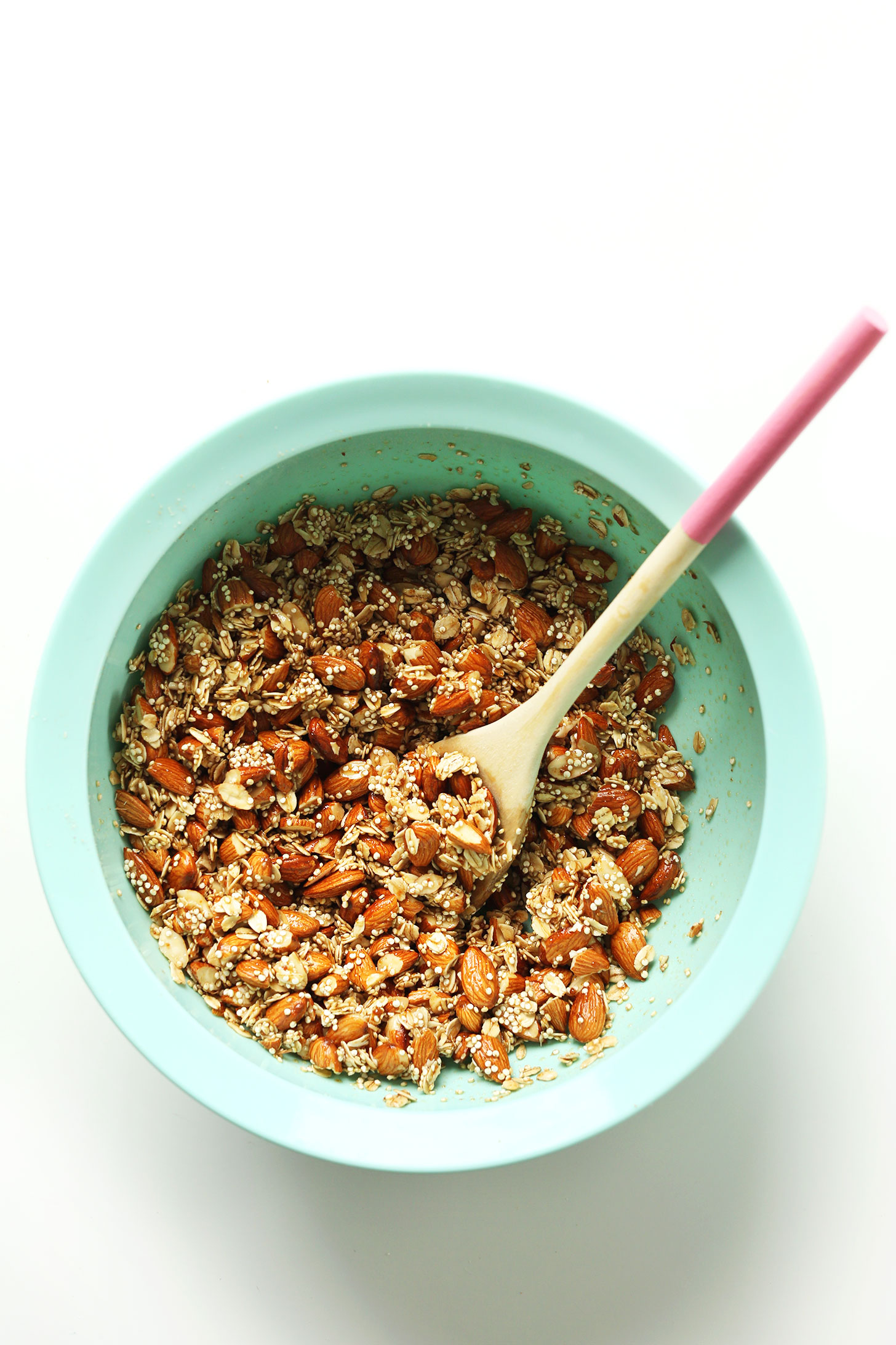Mixing bowl with freshly stirred ingredients for Quinoa Granola with Oats & Almonds