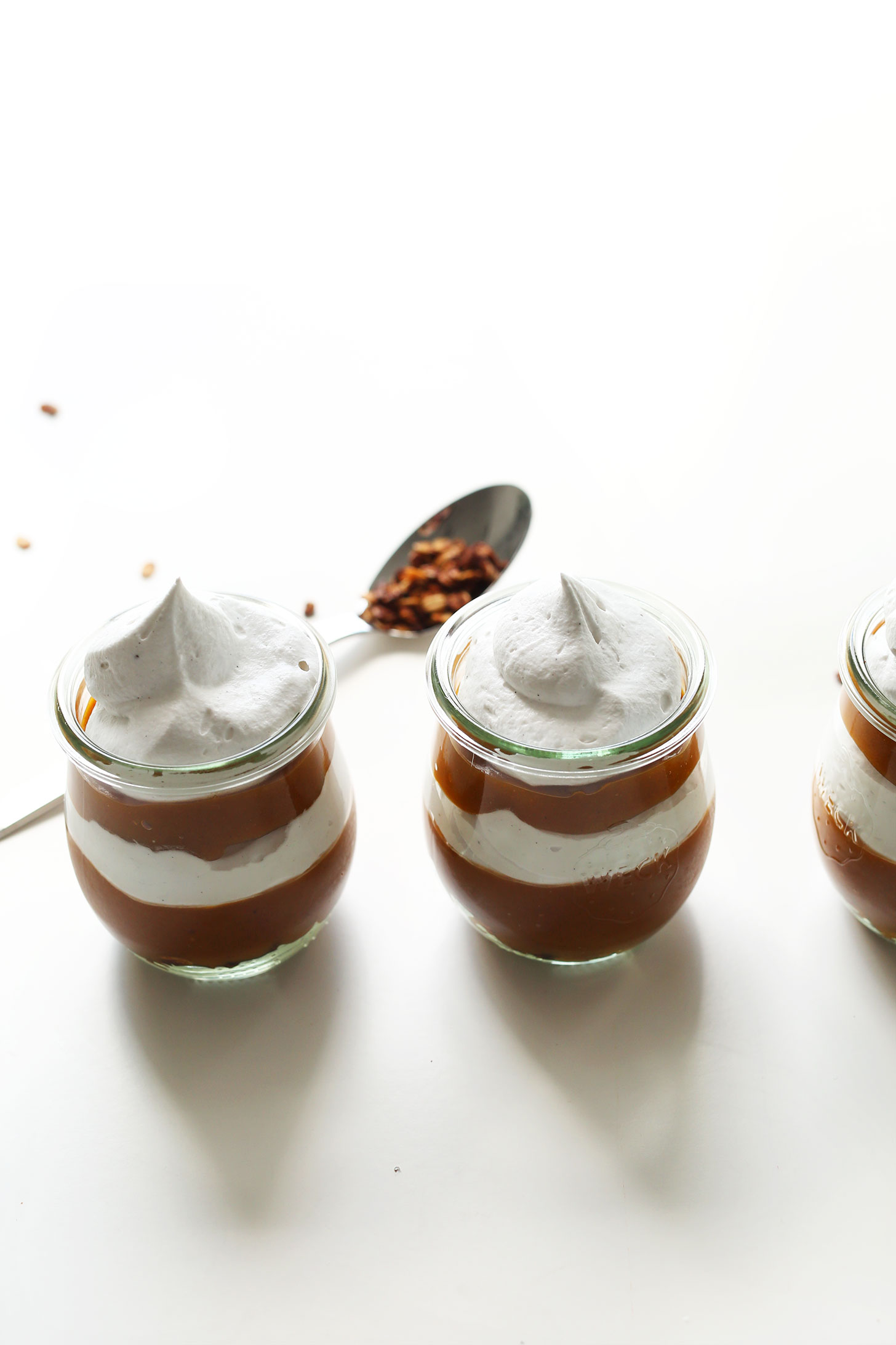 Beautiful layers of pumpkin butter and coconut whipped cream for Pumpkin Pie Parfaits