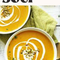 Swirls of coconut milk on bowls of our vegan gluten-free curried butternut squash soup