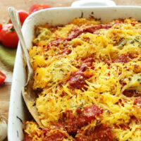Pan of vegan and gluten-free spaghetti squash lasagna bake with a spoon in it