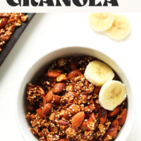 Bowl of high protein quinoa granola with sliced bananas