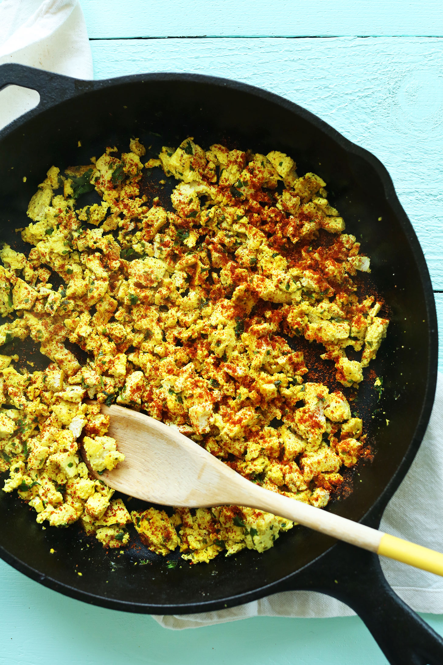 Cooking Savory Tofu Scramble in a cast-iron skillet for a protein-packed vegan breakfast