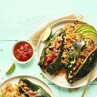 Plate of Stuffed Poblano Peppers with rice and sliced avocado