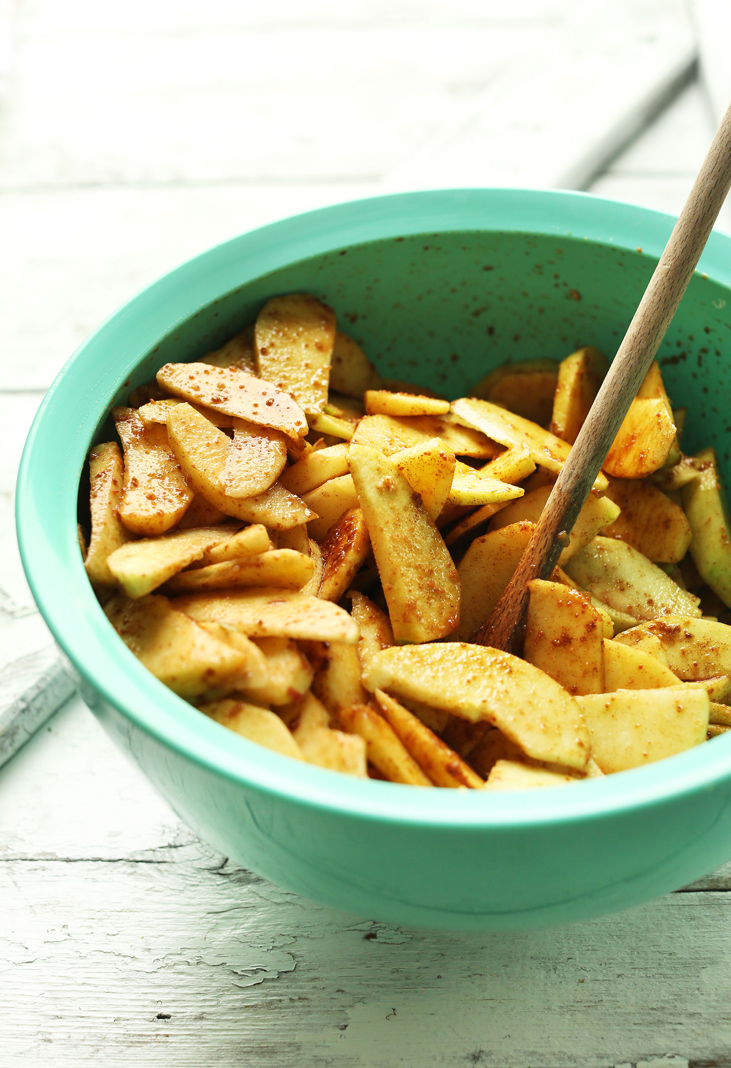 Apples coated with cinnamon and other ingredients for a delicious vegan fall dessert