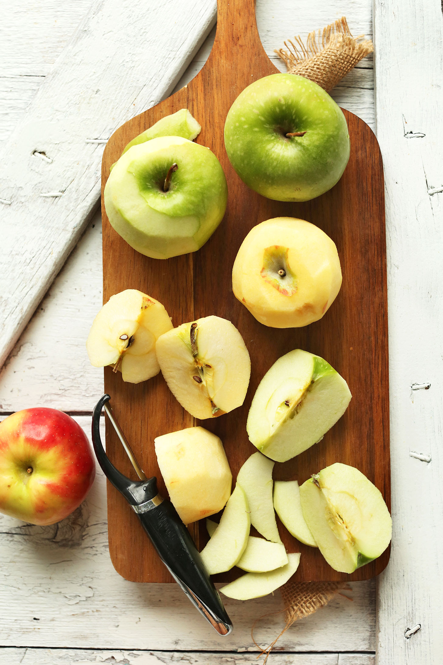 Apples on a cutting board for making delicious naturally-sweetened vegan apple crisp