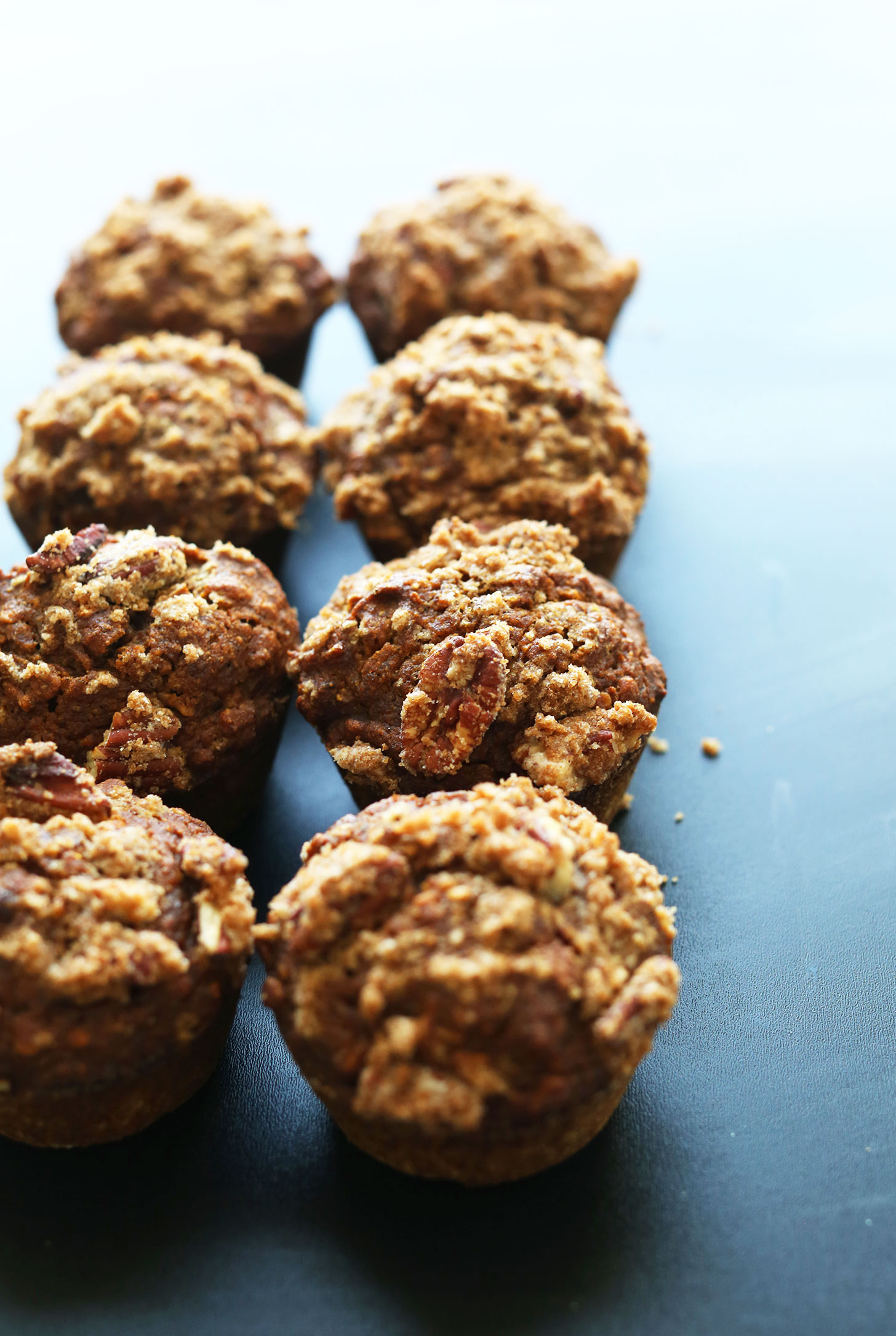 Eight Vegan Pumpkin Spice Muffins with Pecan Crumble Topping for a simple fall dessert