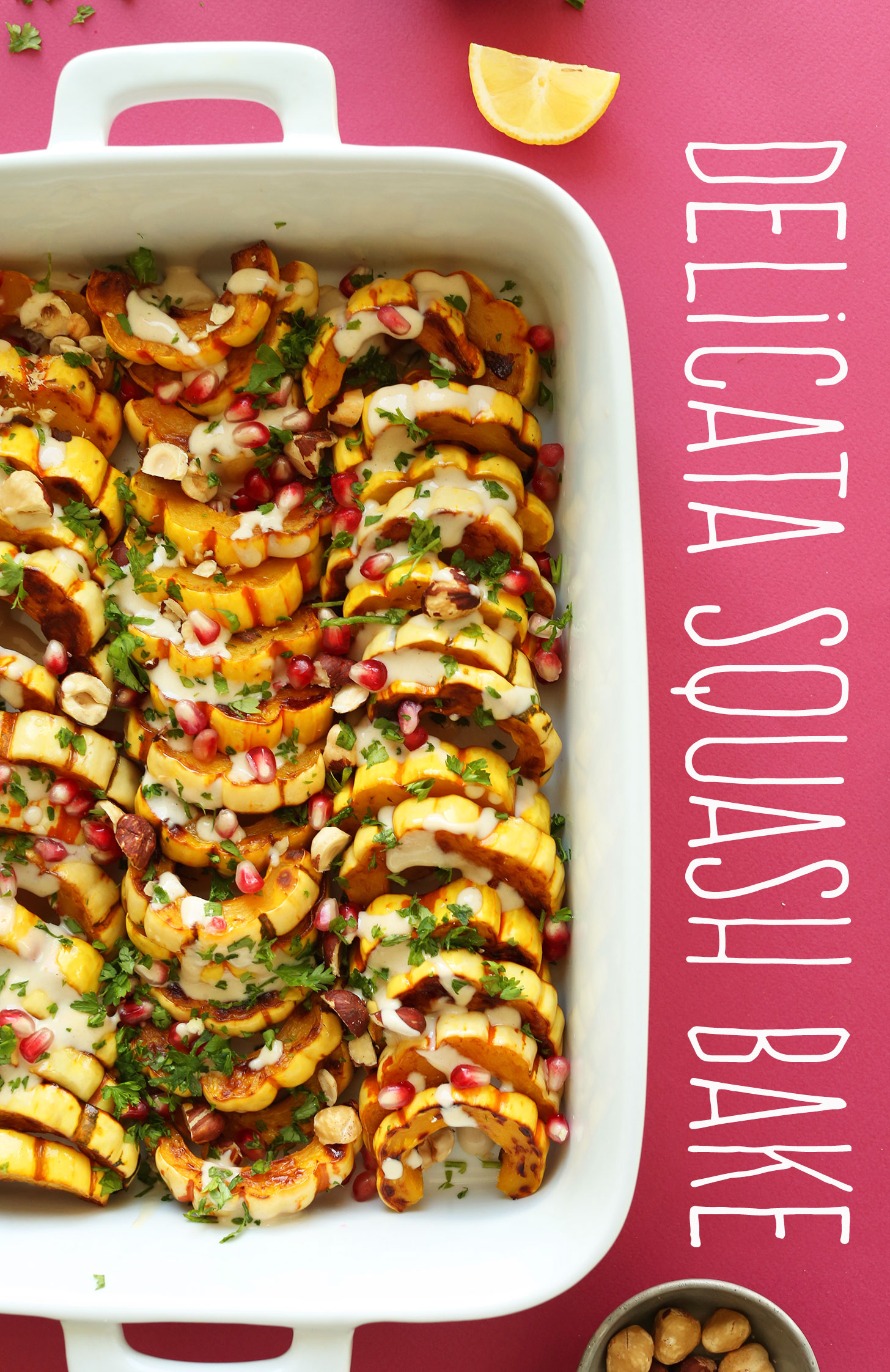 Baking pan filled with our gluten-free Delicata Squash Bake with Hazelnuts, Pomegranates, and Tahini Sauce
