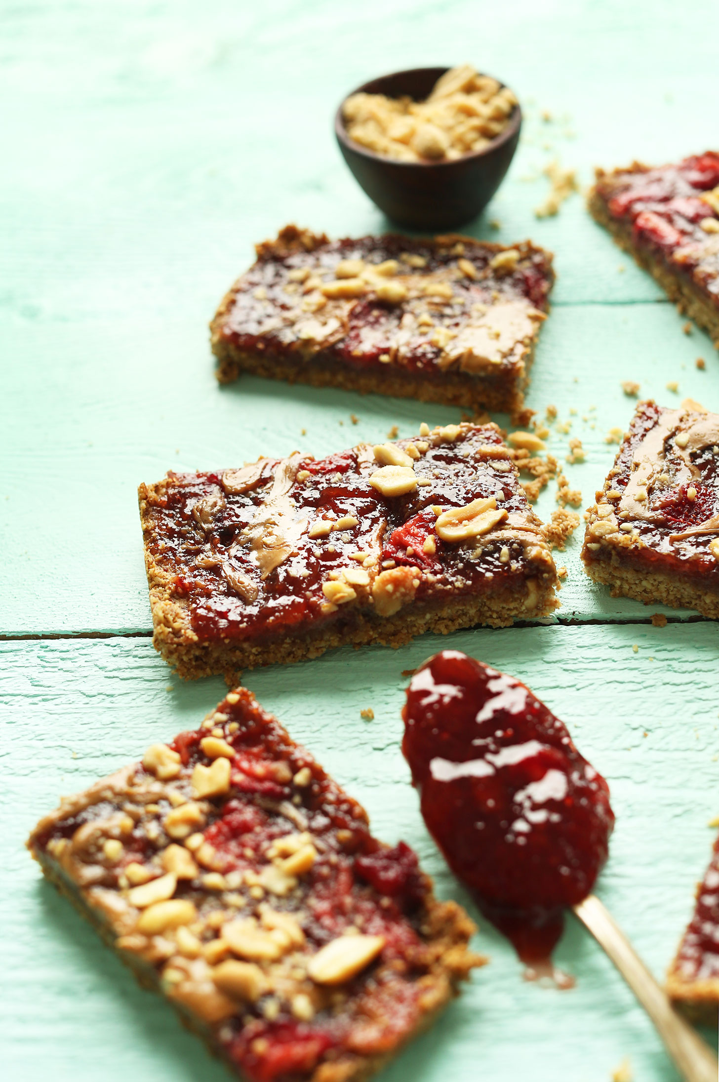 Squares of our gluten-free vegan PB&J Oat Bars for a healthy vegan snack