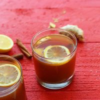 Two glasses of our Apple Cider Hot Rooibos Toddy recipe topped with sliced lemon