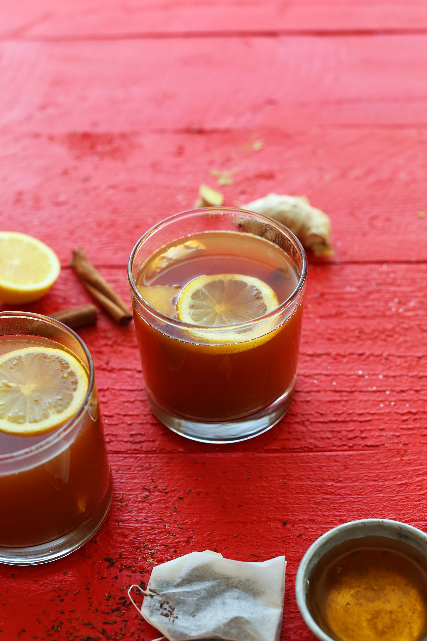 Glasses of our Warm Apple Cider Rooibos Hot Toddy recipe with ginger and lemon