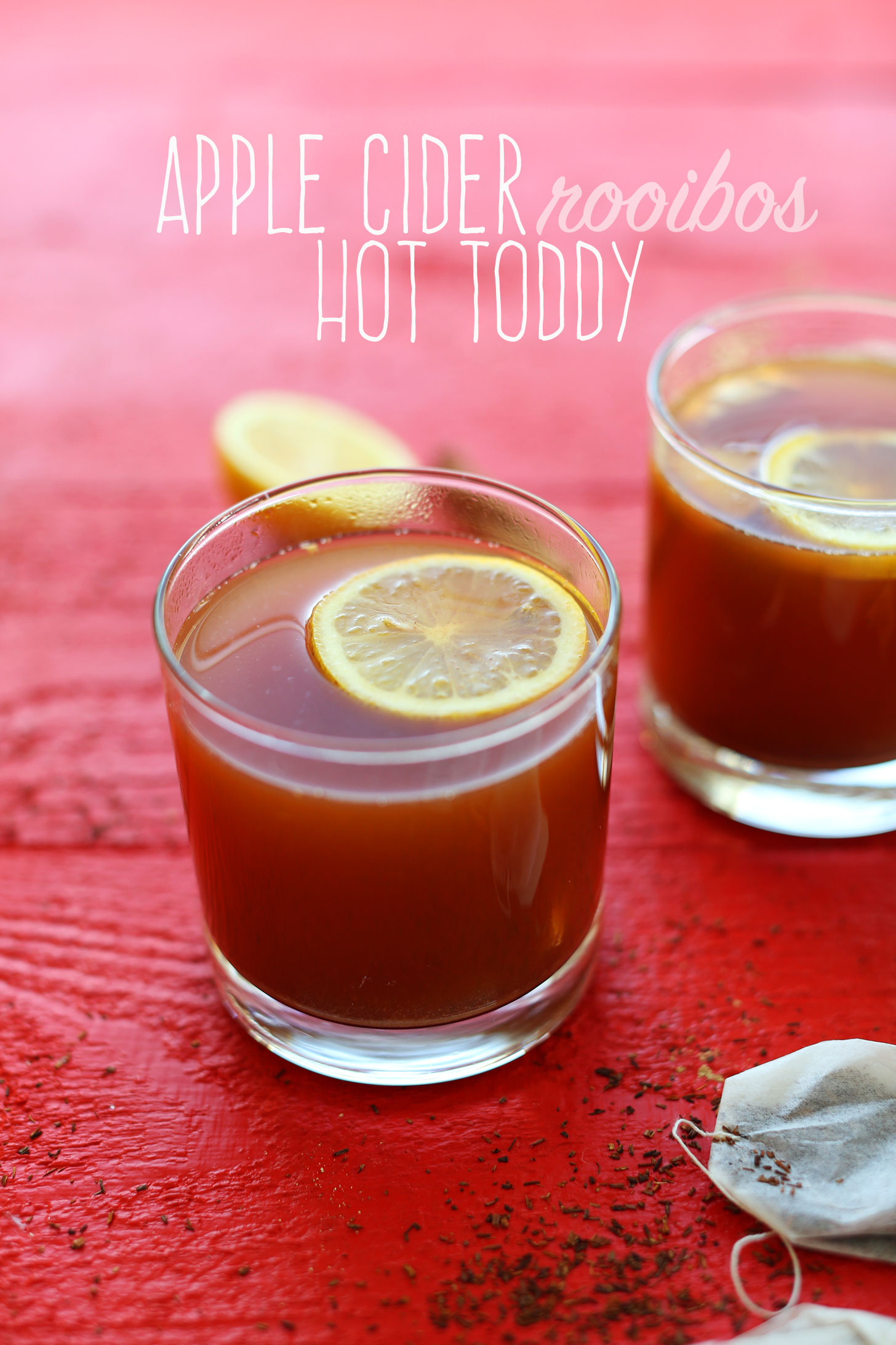 Glasses filled with our Apple Cider Rooibos Hot Toddy recipe and sliced lemons