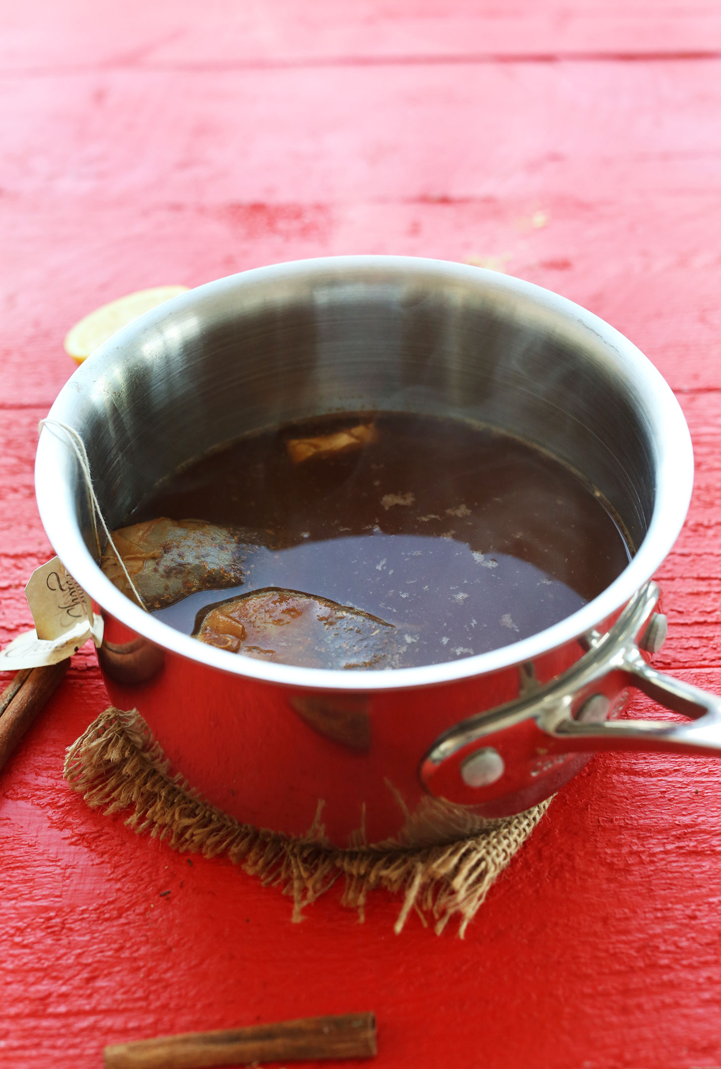 Brewing rooibos tea bags in a saucepan for our Rooibos Hot Toddy recipe