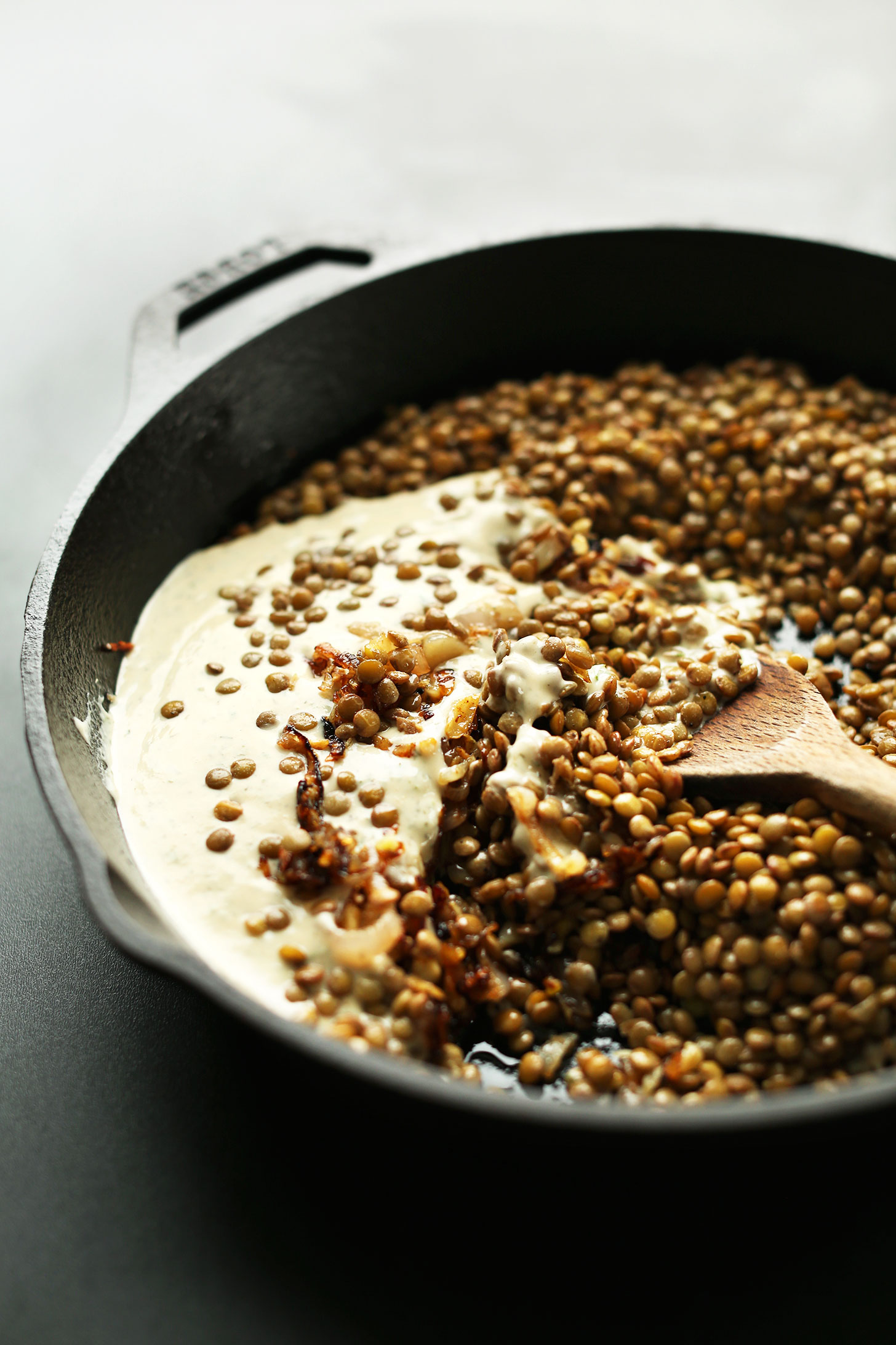 Cooking gluten-free vegan Mediterranean Lentil Dip in a cast-iron skillet
